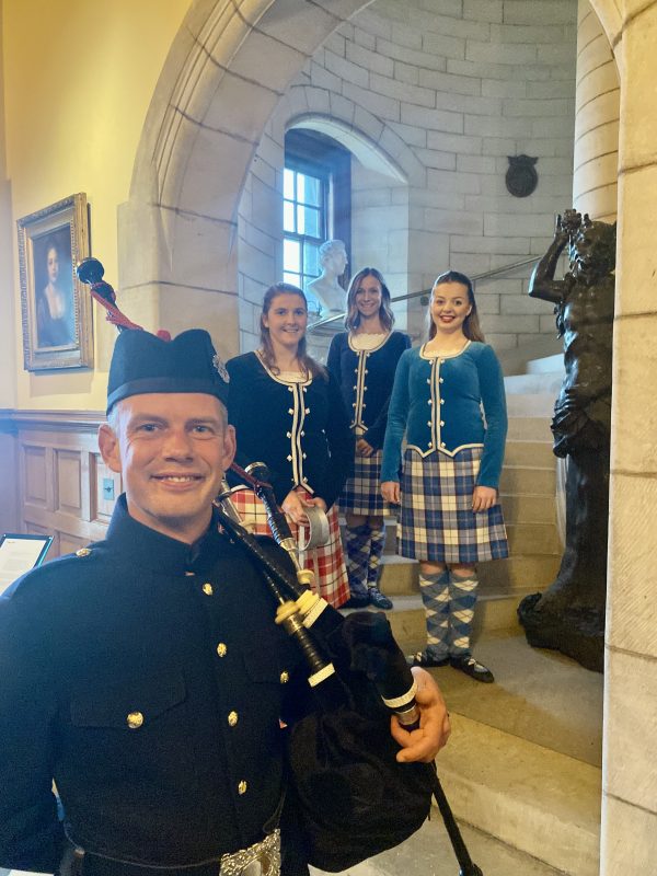 Bagpiper and Scottish Highland Dancers